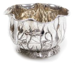 A late 19thC Wang Hing silver bowl, of fluted water lily form, embossed with a crab, newts and vario