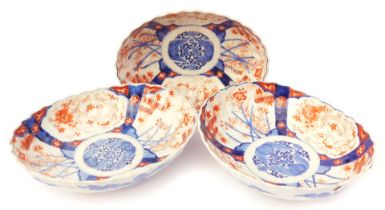 Three Meiji period Japanese Imari dishes, of oval, fluted form, decorated with reserves of bats, dra