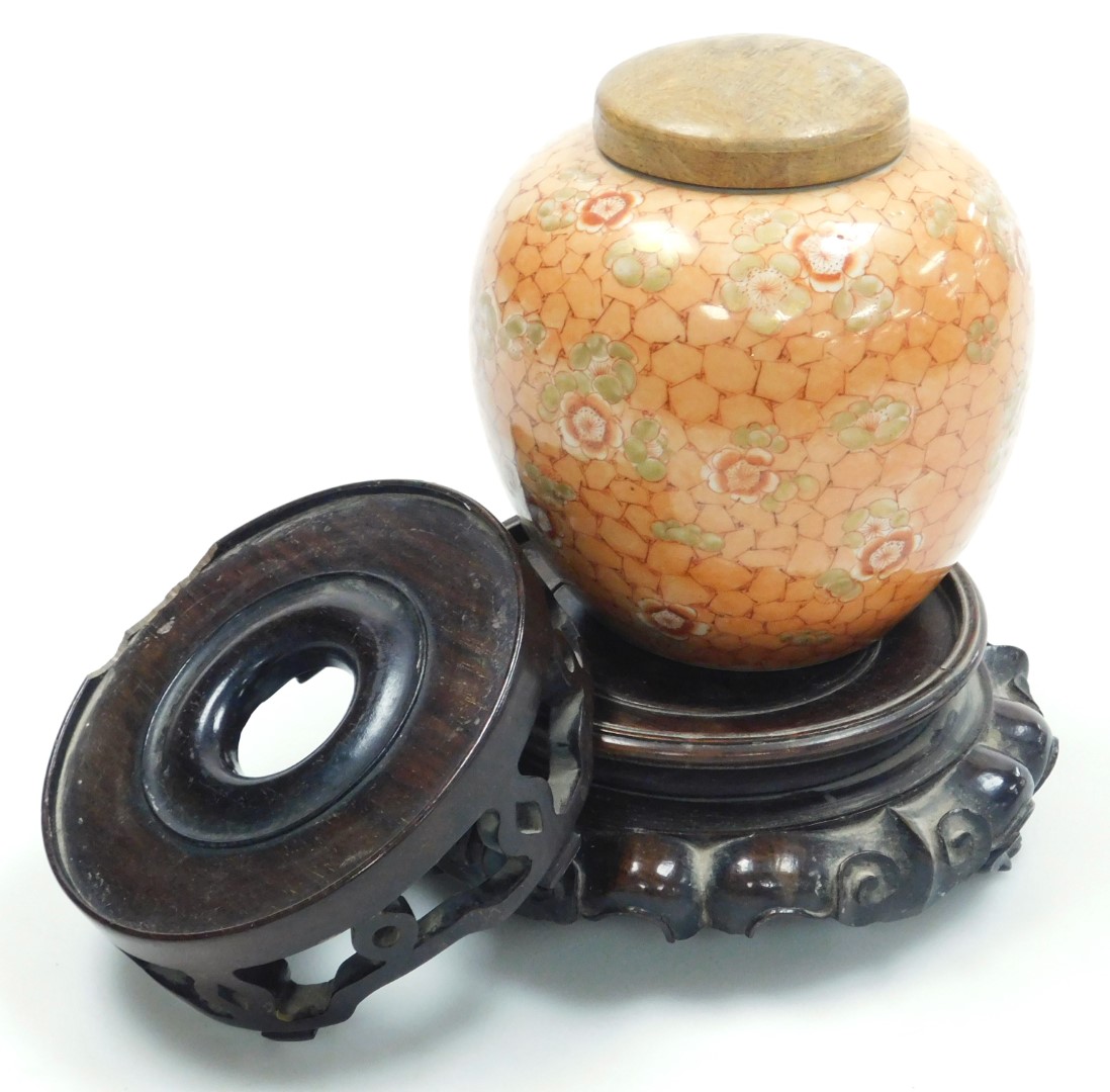 A late 19thC Qing dynasty porcelain ginger jar, with a wooden cover, decorated with prunus blossom o