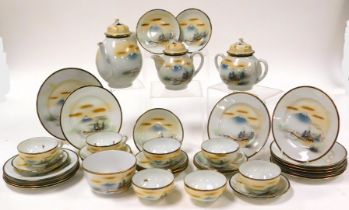 An early 20thC Japanese eggshell porcelain part tea service, decorated with a landscape and Mount Fu