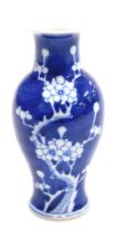 A 20th C blue and white Chinese porcelain vase, of baluster form, decorated with prunus blossom on a