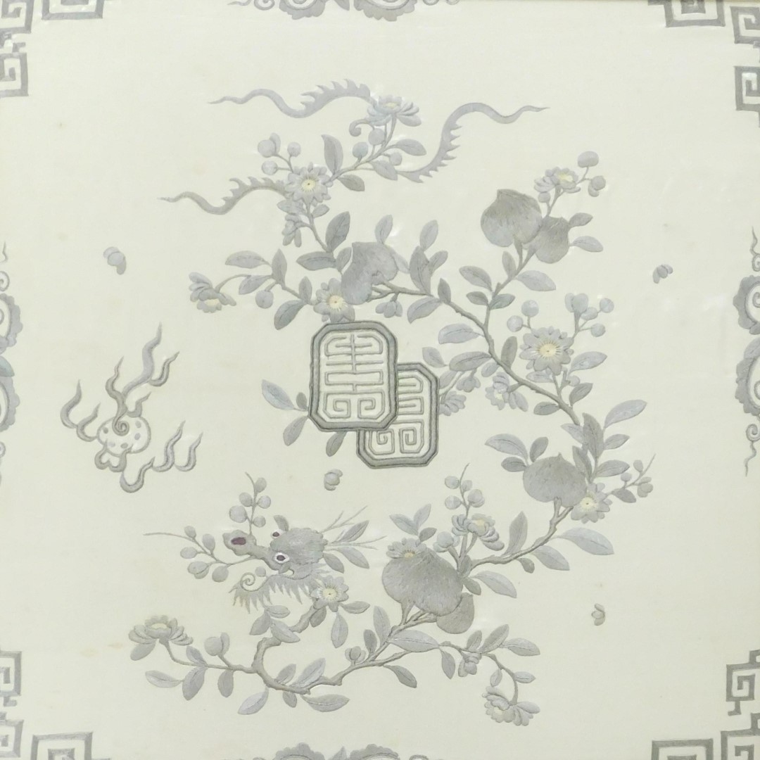 A 19thC Qing dynasty silk panel, decorated wit a peach tree, the head of a dragon, and flaming pearl