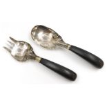 A Malaysian serving fork and spoon set, white metal, chased and pierced with stylised flowers and dr