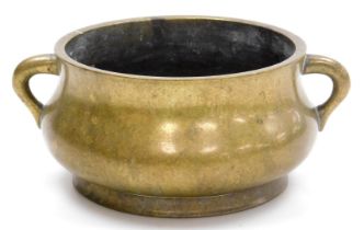 A Chinese bronze censer, probably 18thC, of bombé form, with lug handles, bearing six character Xuan