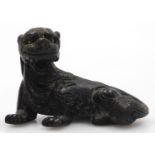 A 19thC Chinese bronze scroll weight modelled as a recumbent dog of fo, 5cm long.