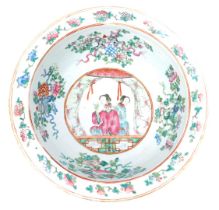 A 19thC Qing dynasty famille rose porcelain wash bowl, decorated internally with two ladies at a win