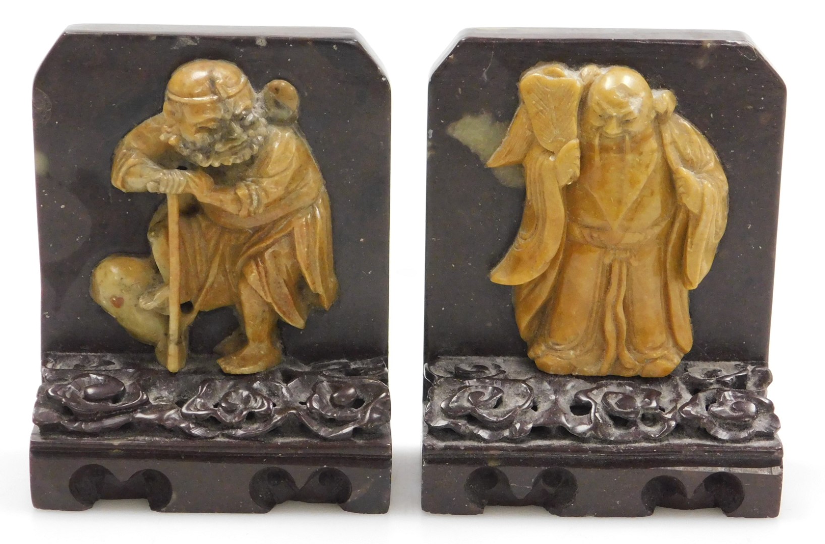 A pair of late 19thC Qing dynasty soapstone bookends, carved with immortals on a cloud ground, and c - Image 2 of 6