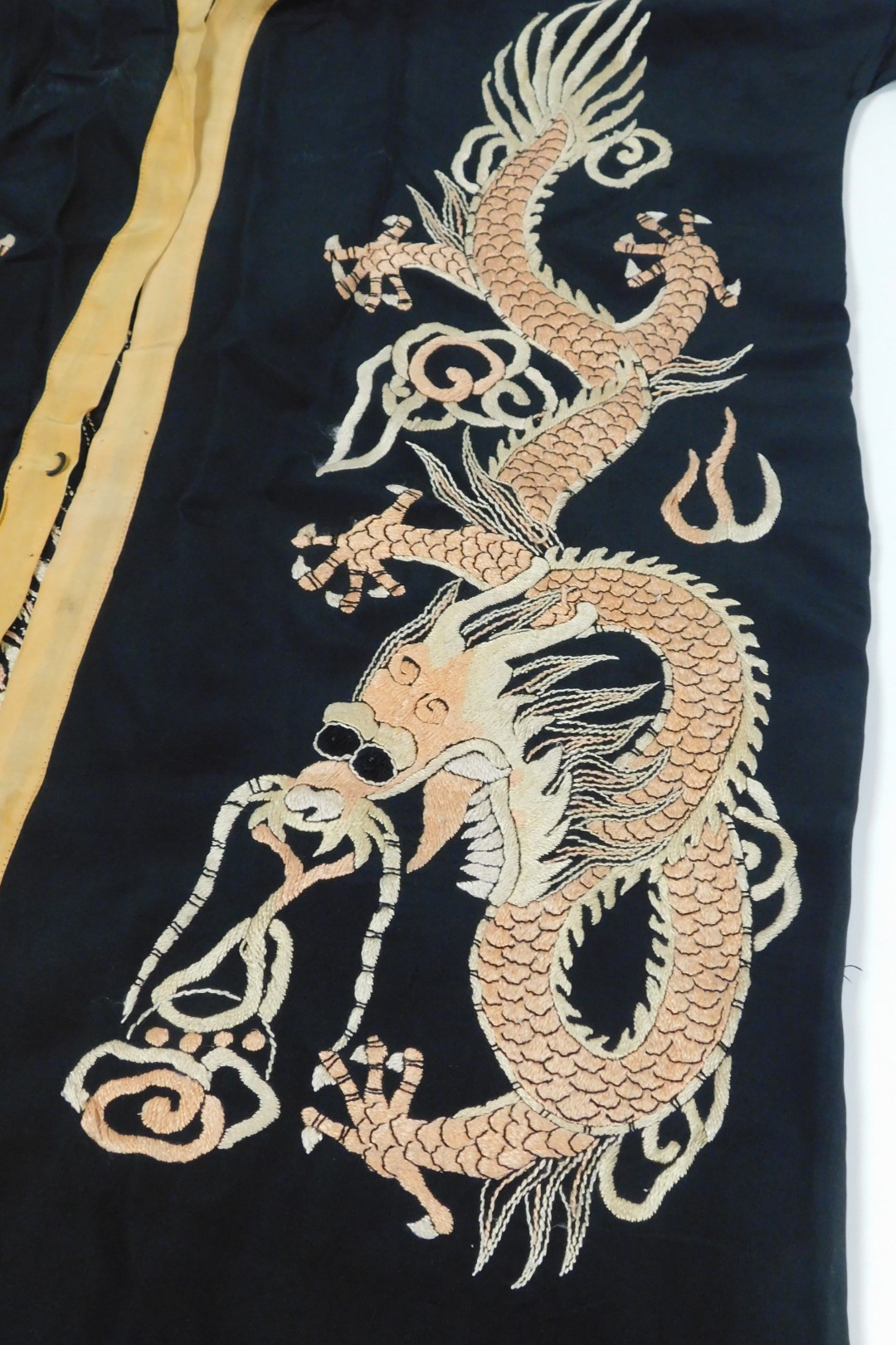 An early 20thC Chinese black silk short surcoat, embroidered with dragons in pink and white, with pe - Image 3 of 5