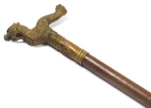 A Meiji period lacquered metal and brass walking stick, with a Shochihoko formed handle, the shaft g