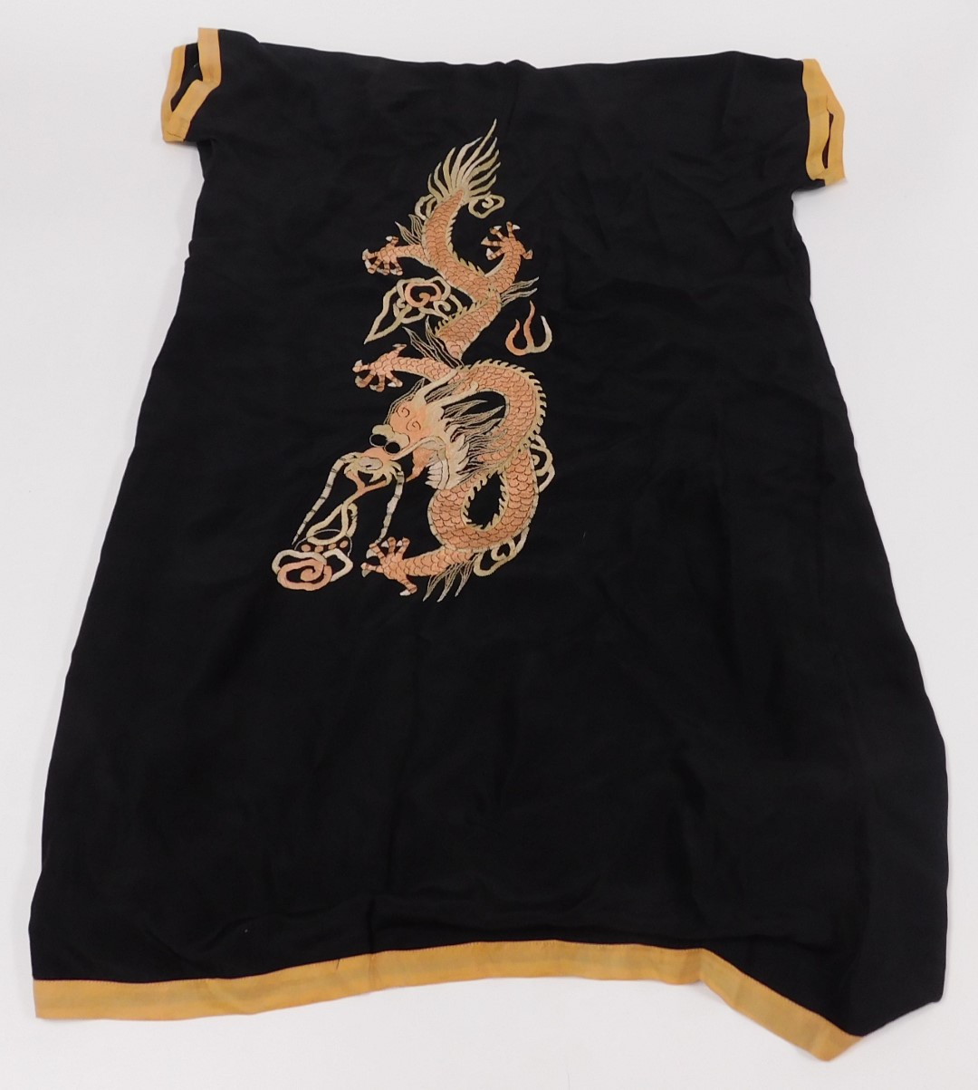 An early 20thC Chinese black silk short surcoat, embroidered with dragons in pink and white, with pe - Image 5 of 5