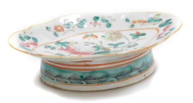 A Tonghzi famille rose porcelain dish, of oval footed form, decorated with flowers, externally with