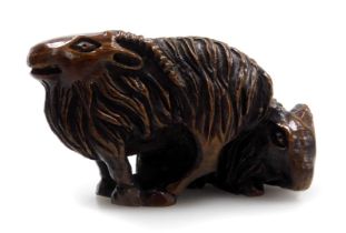 A contemporary Japanese hardwood netsuke, carved as two rams, signed, 4.5cm wide.