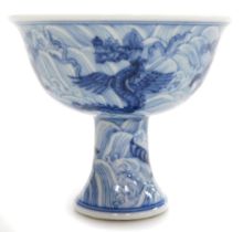 A Ming dynasty style blue and white porcelain wine cup, of stemmed form, decorated with a dragons, F
