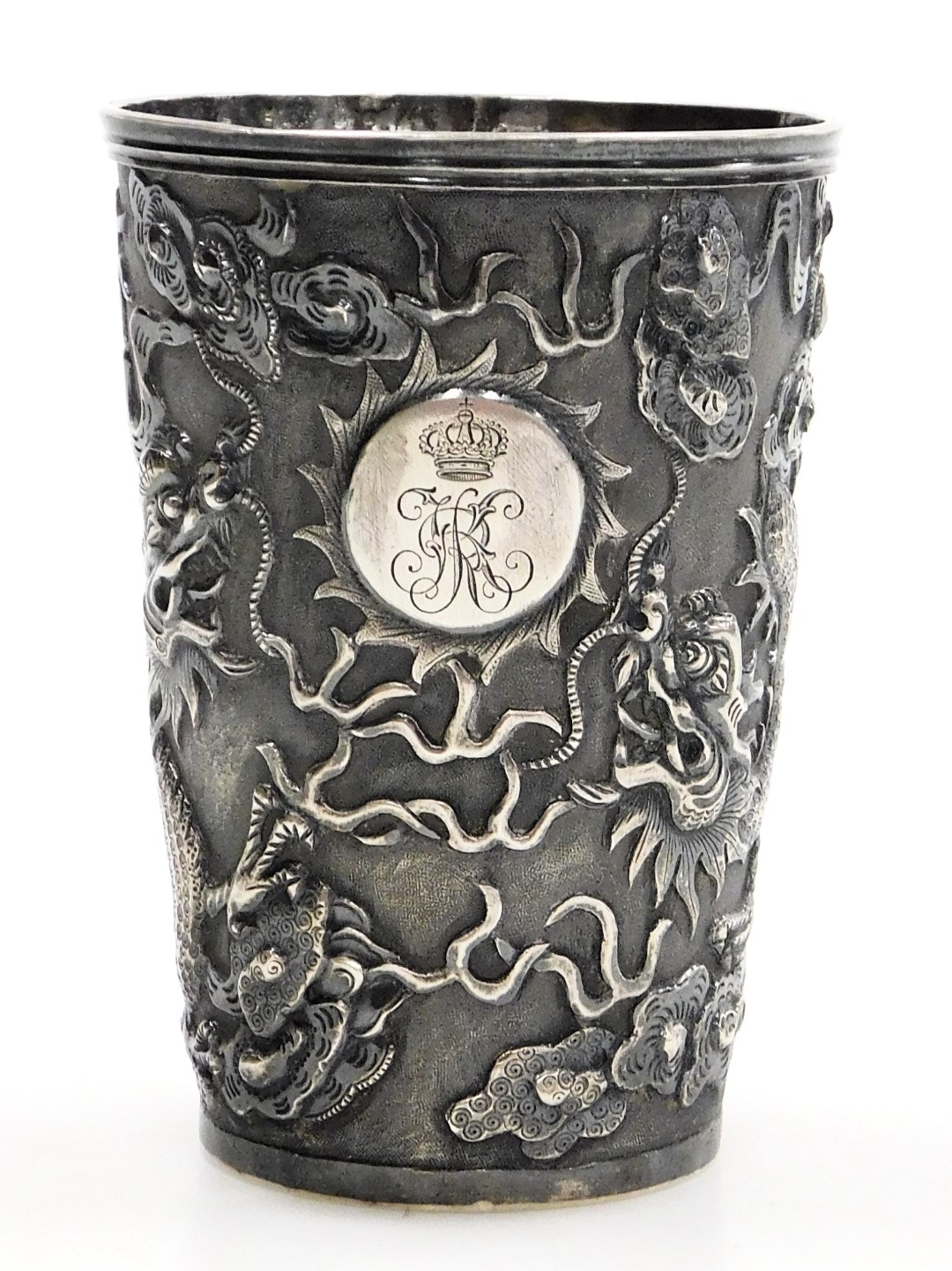 A Hung Chong silver beaker, repousse decorated with dragons chasing a flaming pearl, with a circular