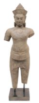 A Khmer sandstone figure of Vishnu, in standing pose, possibly 12th/13thC, modelled wearing a sampot