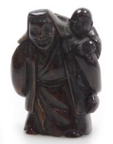 A contemporary Japanese style hardwood netsuke, carved as an elderly man with a boy upon his shoulde