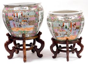 A pair of late 20thC Cantonese famille rose porcelain fish bowls, decorated with reserves of figures