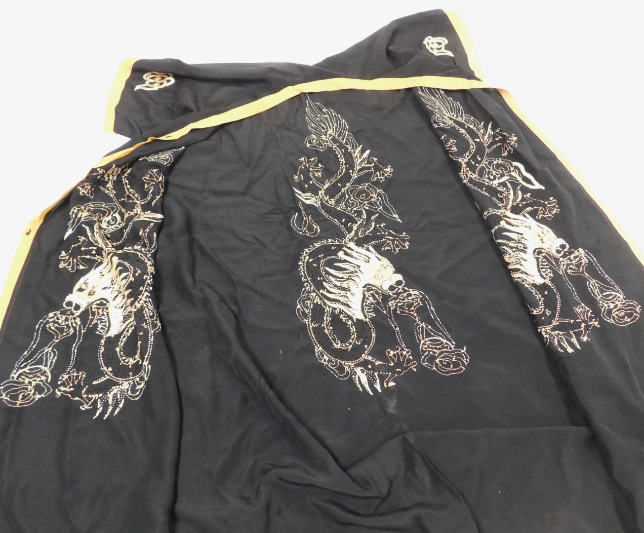 An early 20thC Chinese black silk short surcoat, embroidered with dragons in pink and white, with pe - Image 4 of 5