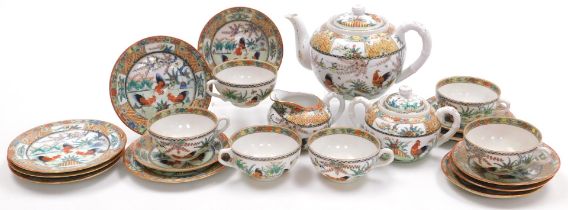 A 20thC Chinese porcelain famille rose part tea service, decorated with roosters, within a border wi