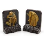 A pair of late 19thC Qing dynasty soapstone bookends, carved with immortals on a cloud ground, and c