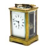 A brass carriage clock, rectangular enamel dial bearing Roman numerals, twin barrel movement with co