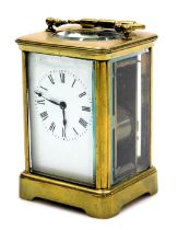 A brass carriage clock, rectangular enamel dial bearing Roman numerals, twin barrel movement with co