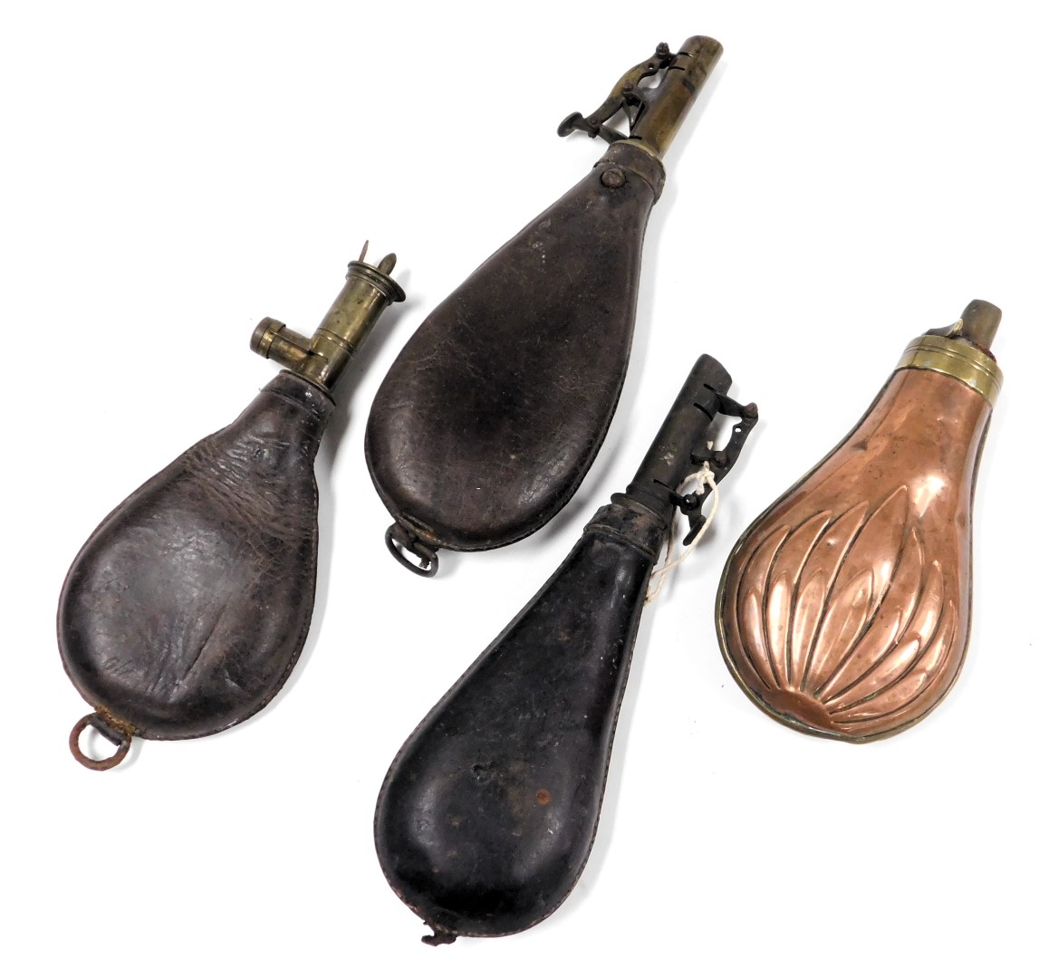 A 19thC copper and brass mounted shot flask, with embossed decoration, 17cm high, together with thre