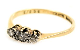 An 18ct gold platinum and diamond three stone ring, size N, 2.0g.
