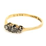 An 18ct gold platinum and diamond three stone ring, size N, 2.0g.