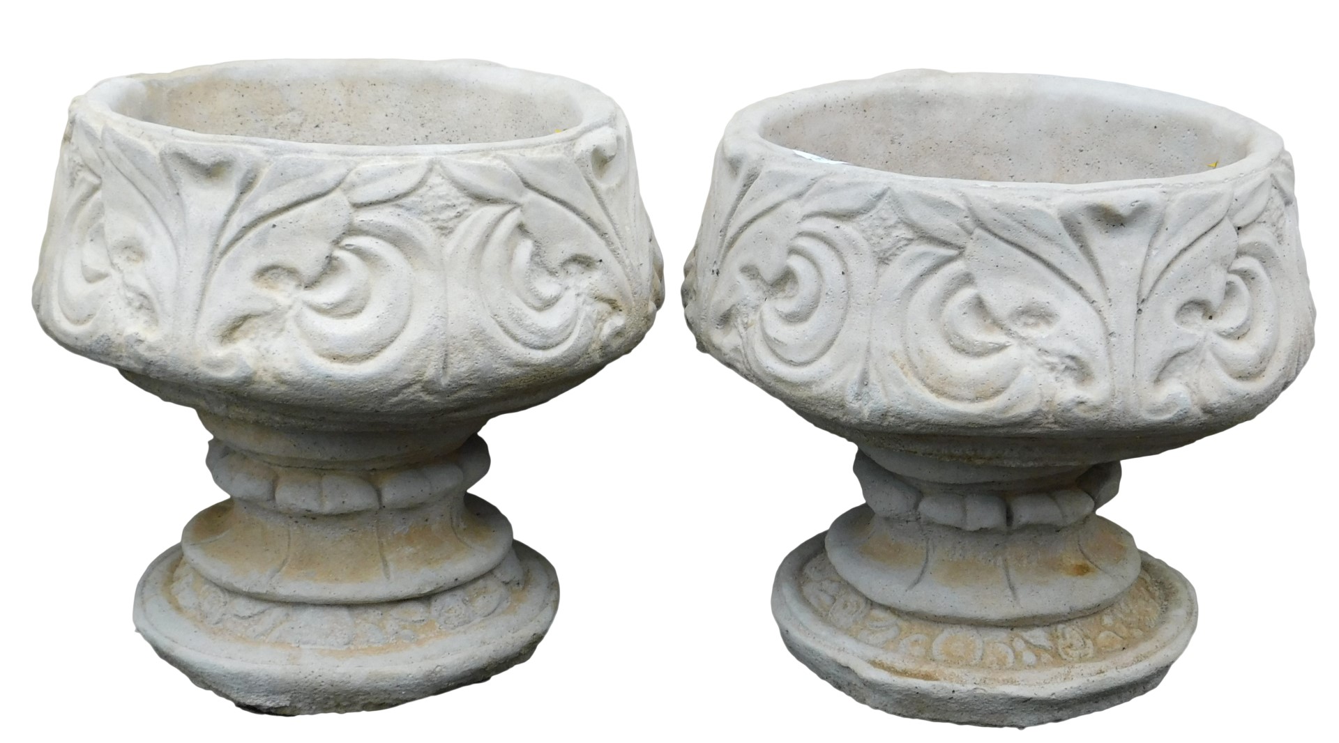 A pair of concrete circular footed planters, with leaf decoration, 39cm wide.