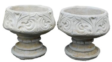 A pair of concrete circular footed planters, with leaf decoration, 39cm wide.