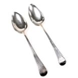 A pair of George III silver tablespoons, with bright cut engraving, terminal with monogram reserve,