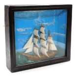 A cased diorama of a three masted sailing ship, sails out, on a choppy sea, 44cm x 49cm.