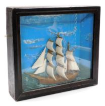 A cased diorama of a three masted sailing ship, sails out, on a choppy sea, 44cm x 49cm.
