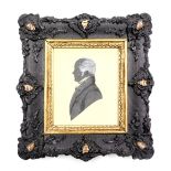 An early 19thC silhouette portrait, study of a gentleman, in a stylised frame, 9.5cm x 8cm.