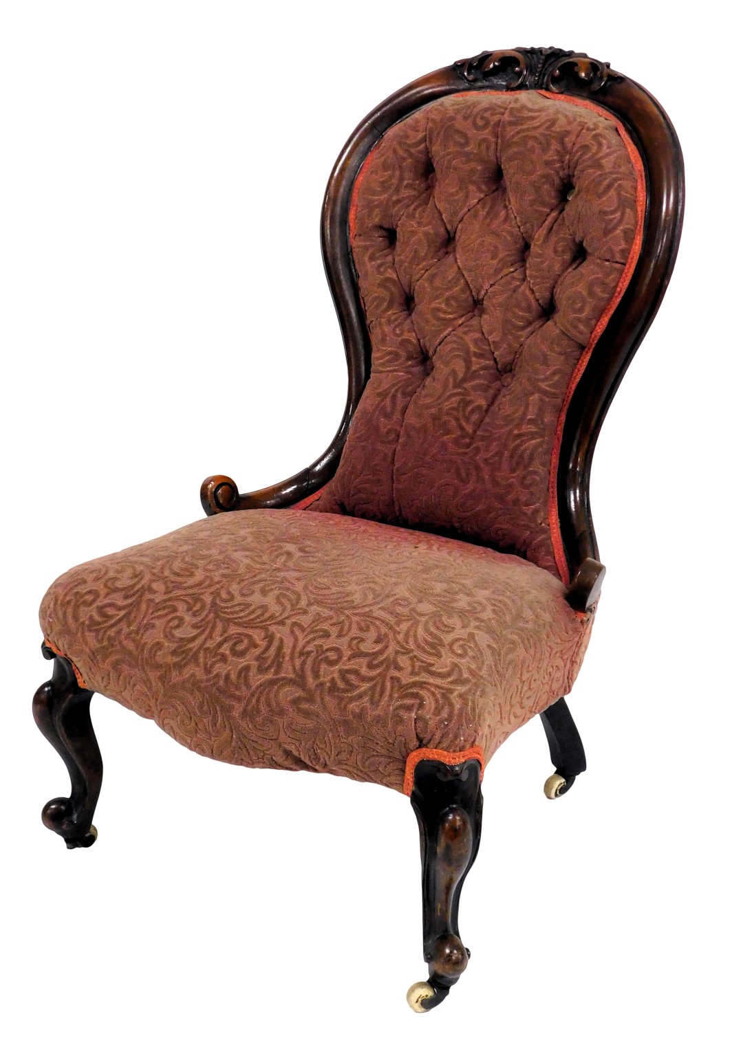 A Victorian mahogany balloon back nursing chair, upholstered in red foliate draylon, raised on cabri