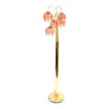 A late 20thC brass standard lamp, with five branch tiered etched pink glass floral shades, 170cm hig