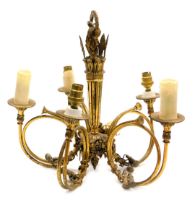 A French Empire style brass five branch chandelier, with scrolling arms, in the form of French horns