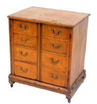 A 19thC mahogany cupboard, with a pair of doors, formed as eight dummy drawers, raised on a plinth b