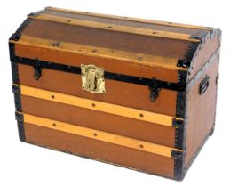 A late 19thC canvas and wooden bound trunk, with metal strap work, 54cm high, 76cm wide, 46cm deep.