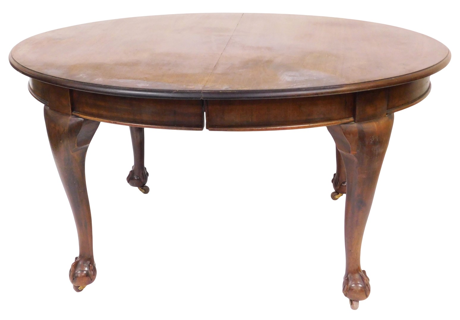 A Victorian mahogany extending dining table, with two leaves, the oval moulded top raised on four ba