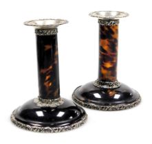 A pair of Victorian silver and tortoiseshell candlesticks, with embossed foliate scroll decoration,