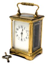 A late 19thC French brass cased carriage clock, rectangular enamel dial bearing Arabic numerals, sin