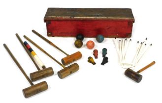 An early 20thC croquet set, with mallets, balls and hoops, pine cased, possibly Jacques, case 24cm h