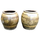 A pair of Chinese brown glazed stoneware barrel planters, decorated with a band of dragons, 46cm hig