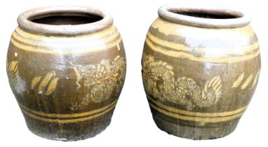 A pair of Chinese brown glazed stoneware barrel planters, decorated with a band of dragons, 46cm hig