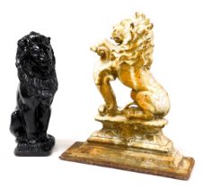 A Victorian cast iron door stop, modelled as a rampant lion, raised on a plinth above a rectangular