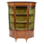 An Edwardian mahogany bow front display cabinet, with glazed sides and a door, glass lacking, above