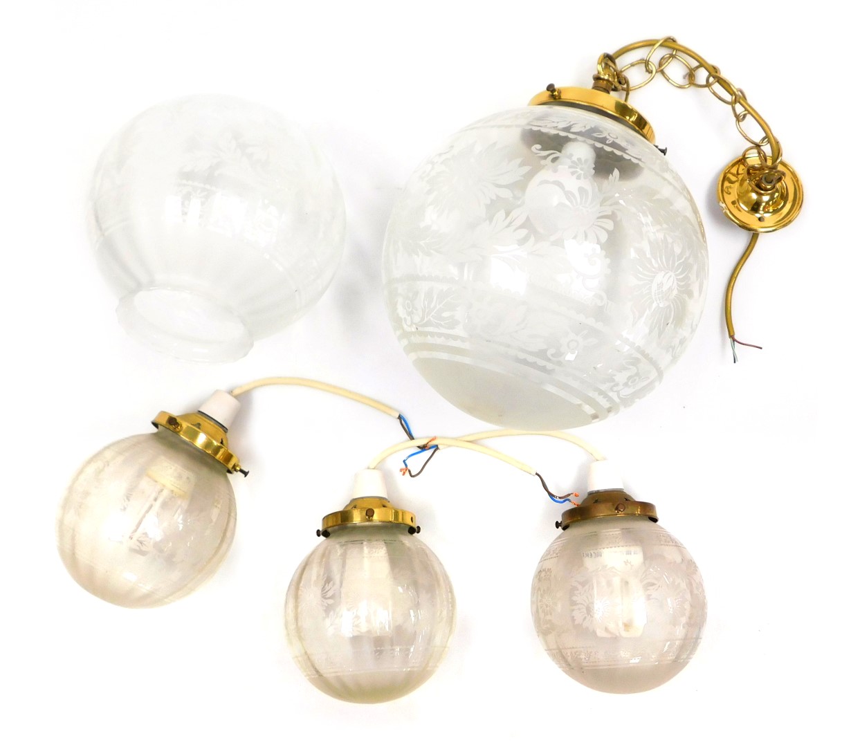 A glass ceiling light, of globular form, with floral decoration, 30cm high, three smaller pendant li