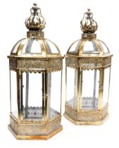 A pair of metal and glass lanterns, with crown finials, of hexagonal form, with pierced foliate band